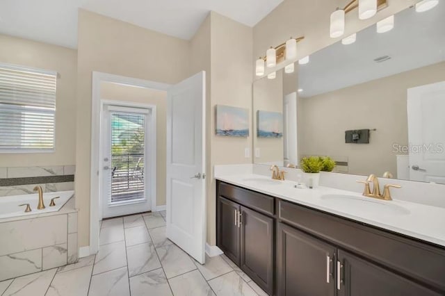 bathroom with tiled bath, tile flooring, oversized vanity, and dual sinks