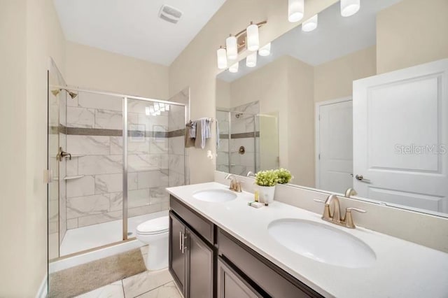 bathroom with a shower with door, toilet, double vanity, and tile flooring