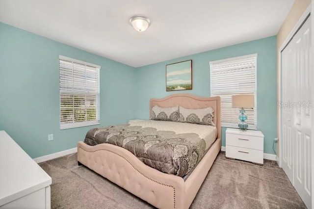 bedroom with light carpet and a closet