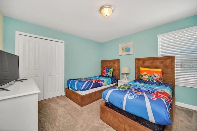 bedroom featuring a closet and carpet flooring