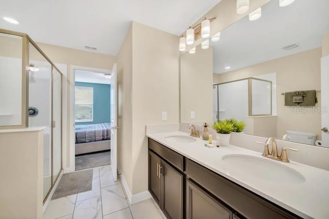 bathroom with a shower with door, oversized vanity, toilet, tile floors, and dual sinks