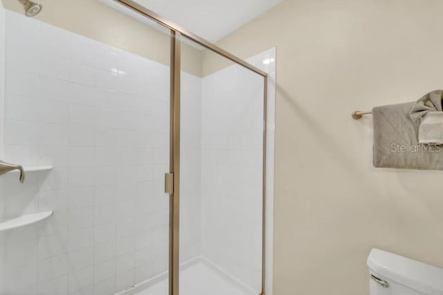 bathroom with walk in shower and toilet