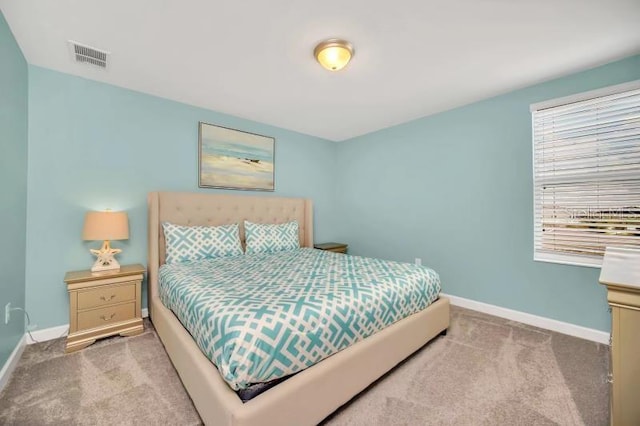 carpeted bedroom featuring multiple windows