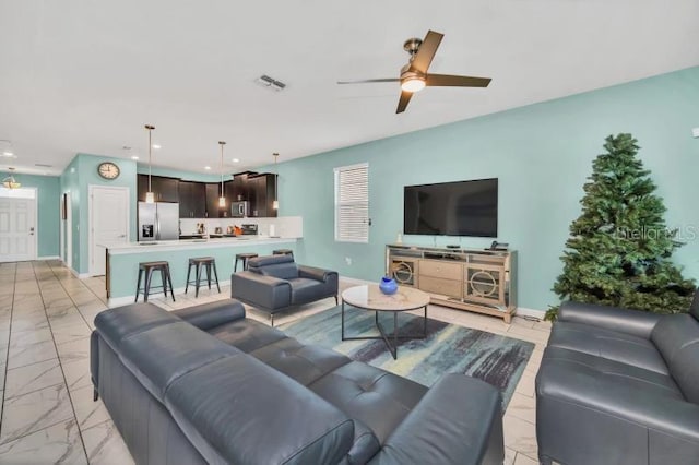 living room with ceiling fan and light tile floors