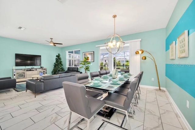 dining room featuring ceiling fan with notable chandelier and light tile flooring