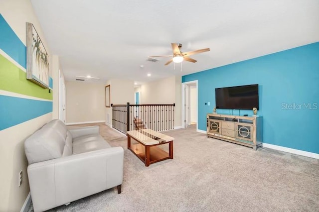 carpeted living room featuring ceiling fan