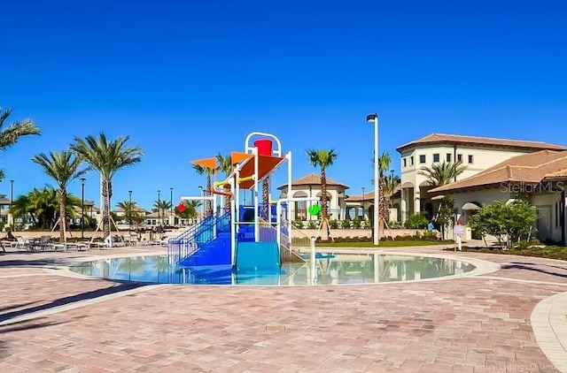 view of jungle gym with a community pool