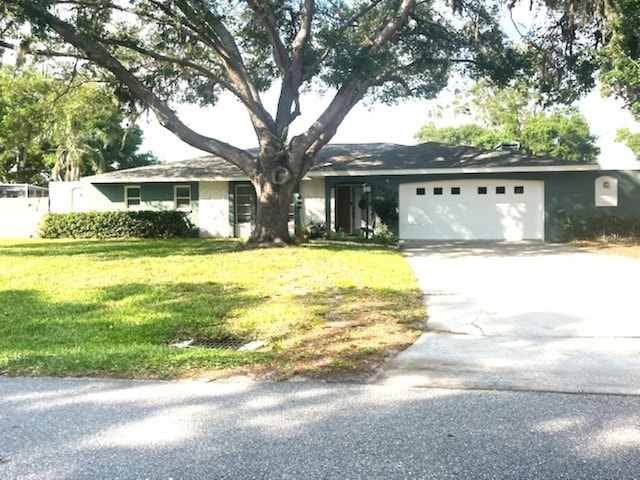 ranch-style house with a front yard and a garage