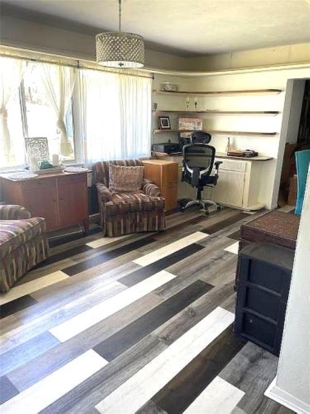 office area with dark hardwood / wood-style flooring and built in desk