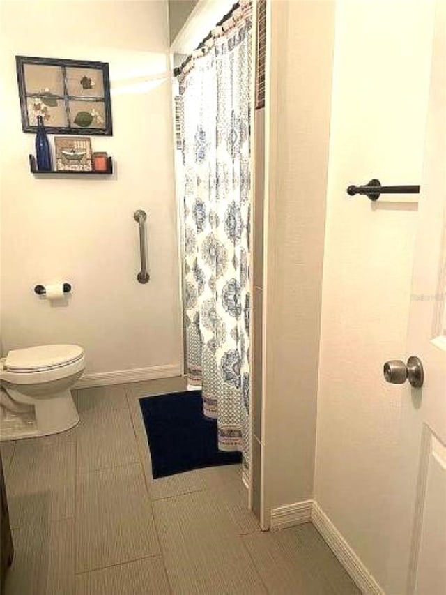 bathroom featuring toilet and walk in shower