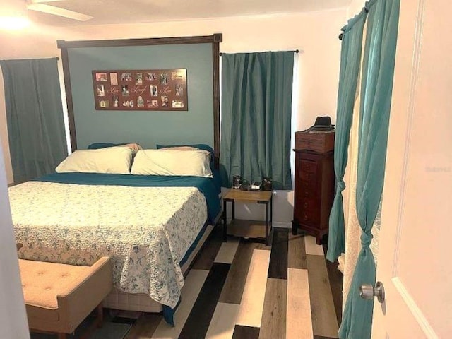 bedroom with ceiling fan and hardwood / wood-style flooring