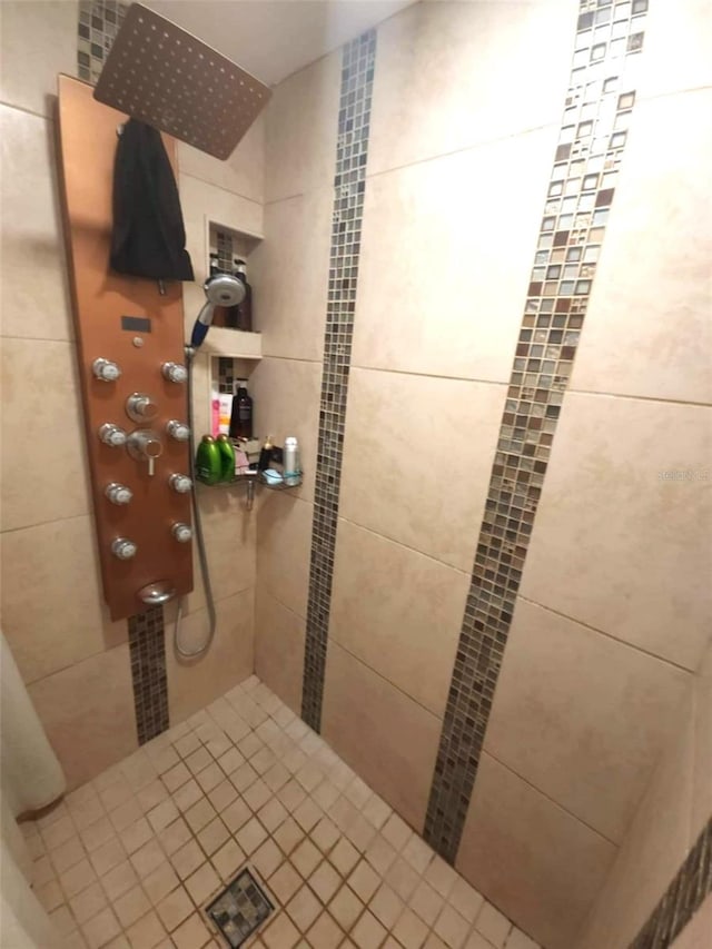 bathroom with a tile shower