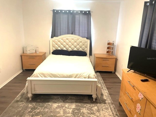 bedroom featuring dark wood-type flooring