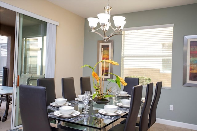 dining area featuring a notable chandelier, light tile floors, and a wealth of natural light