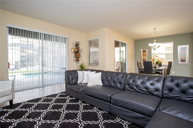 tiled living room featuring a chandelier