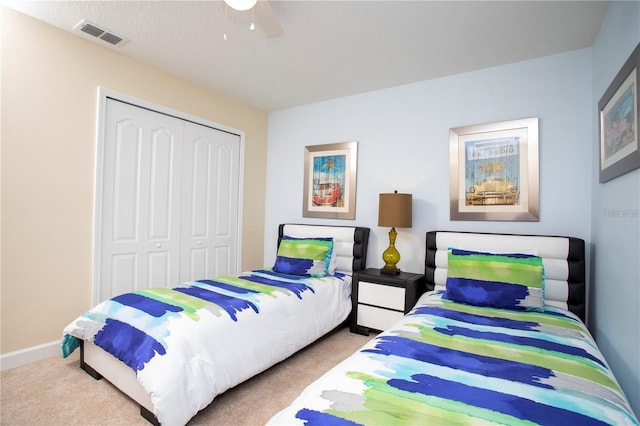 carpeted bedroom with a closet and ceiling fan