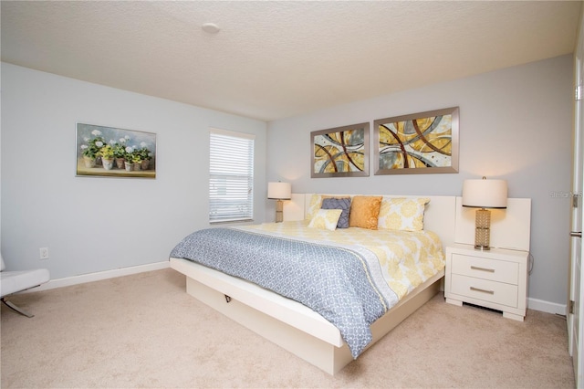 bedroom with light colored carpet and a textured ceiling