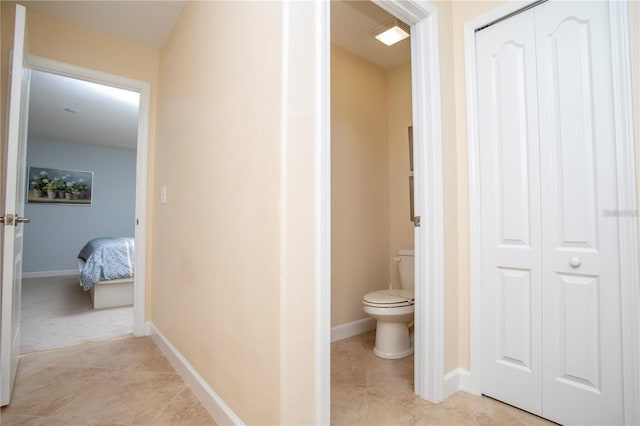 bathroom with toilet and tile flooring