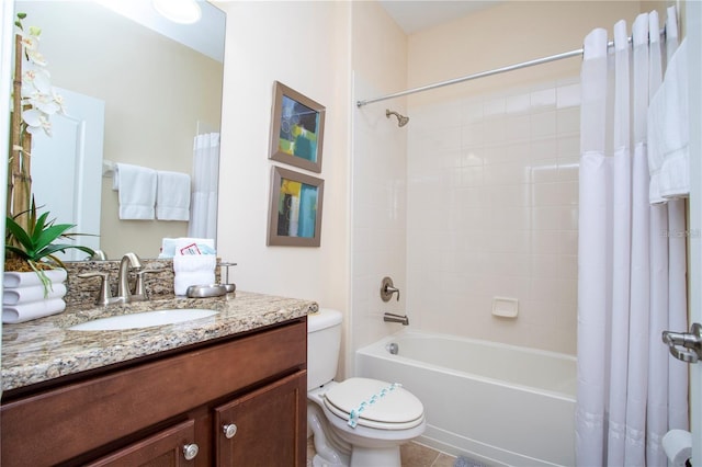 full bathroom with tile floors, shower / tub combo, vanity, and toilet