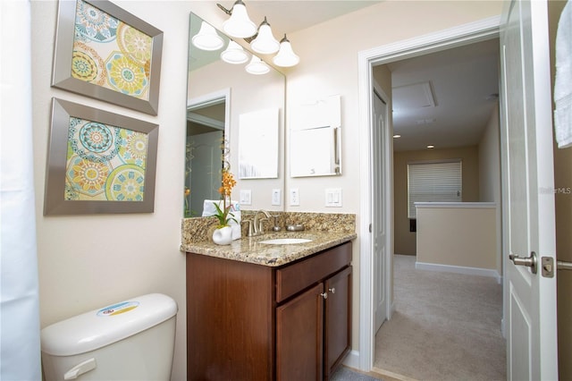 bathroom with vanity with extensive cabinet space and toilet