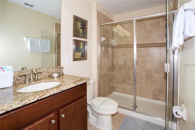 bathroom featuring tile floors, oversized vanity, an enclosed shower, and toilet