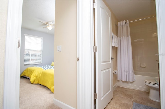 bathroom with tile floors, ceiling fan, toilet, and shower / bathtub combination with curtain