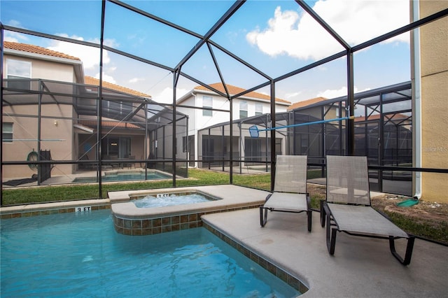 view of swimming pool featuring a patio, a lanai, and an in ground hot tub