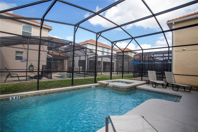 view of swimming pool with a lanai, an in ground hot tub, and a patio area