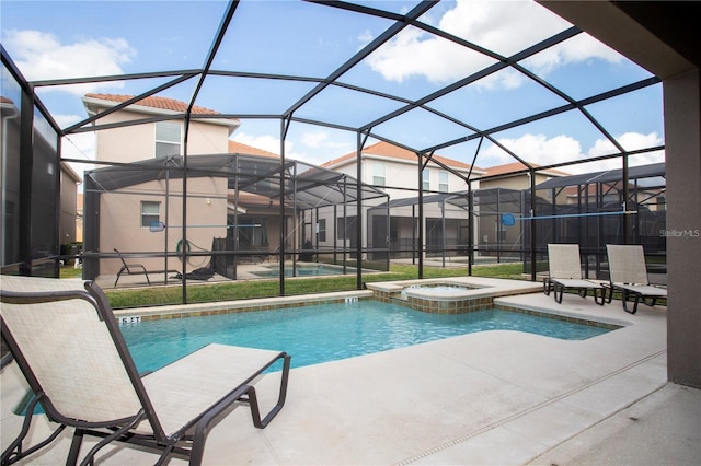 view of pool with a lanai, an in ground hot tub, and a patio area