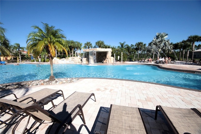 view of swimming pool with a patio and pool water feature