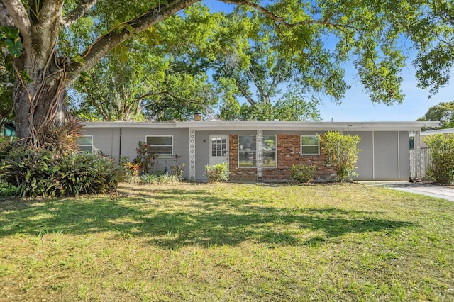 ranch-style home with a front lawn