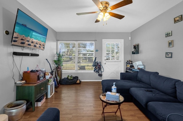 living room with dark hardwood / wood-style floors and ceiling fan