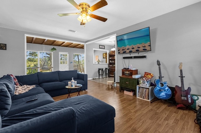 living room with hardwood / wood-style floors, ceiling fan, wood ceiling, and lofted ceiling