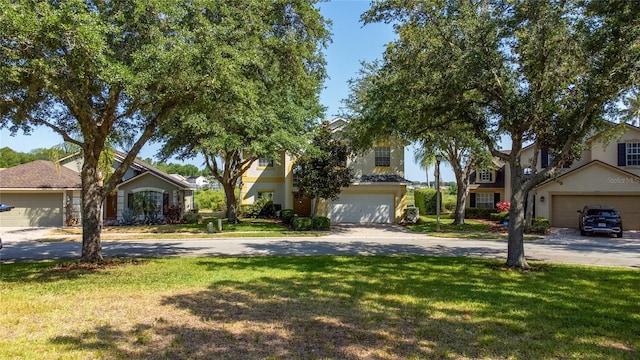 view of front of house featuring a garage and a front lawn