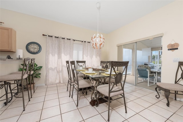 dining area with a chandelier and light tile flooring