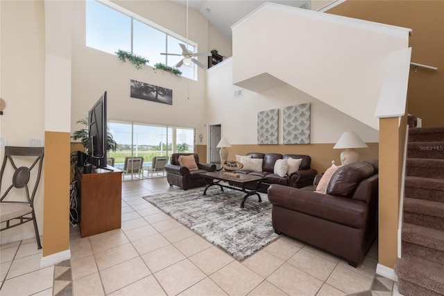 tiled living room with a high ceiling and ceiling fan