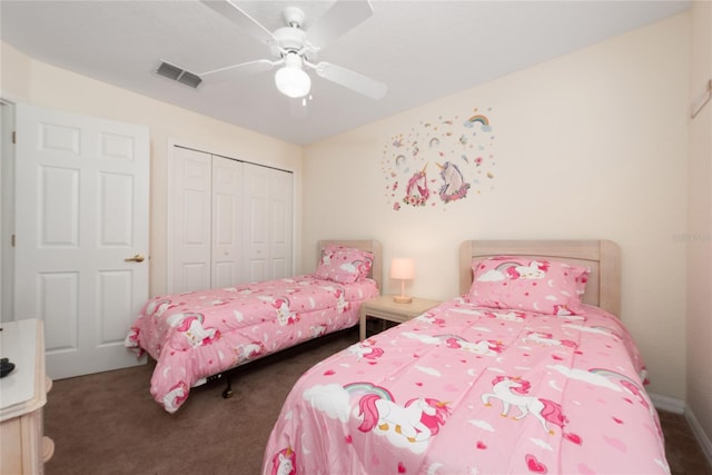 bedroom featuring ceiling fan, a closet, and dark colored carpet