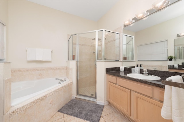 bathroom with plus walk in shower, tile flooring, and vanity