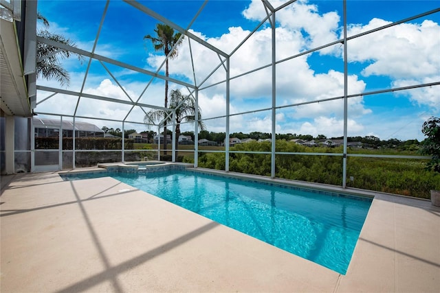 view of swimming pool with a patio area, an in ground hot tub, and a lanai