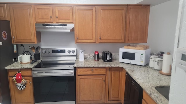 kitchen featuring light stone countertops, black appliances, sink, and tile patterned flooring