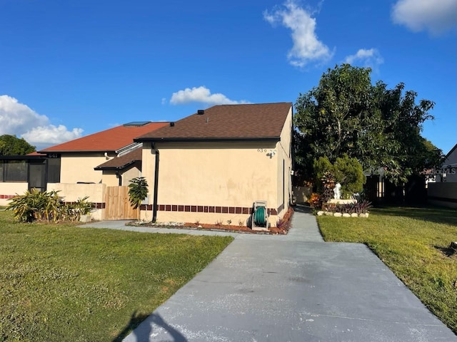 view of side of home featuring a lawn