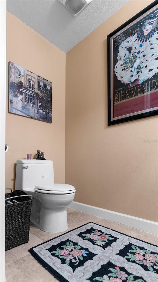 bathroom featuring tile patterned floors and toilet