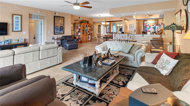 tiled living room featuring ceiling fan with notable chandelier