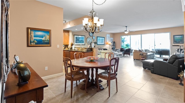 tiled dining area with a notable chandelier and sink