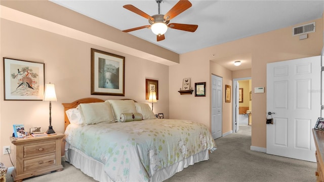 carpeted bedroom with ceiling fan, ensuite bathroom, and a closet