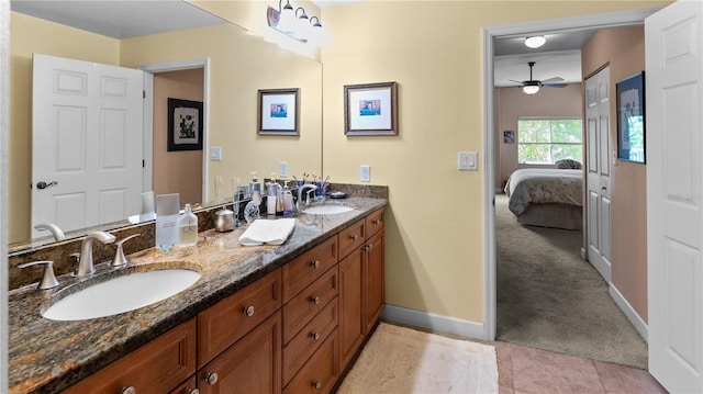 bathroom with ceiling fan, tile patterned floors, and vanity