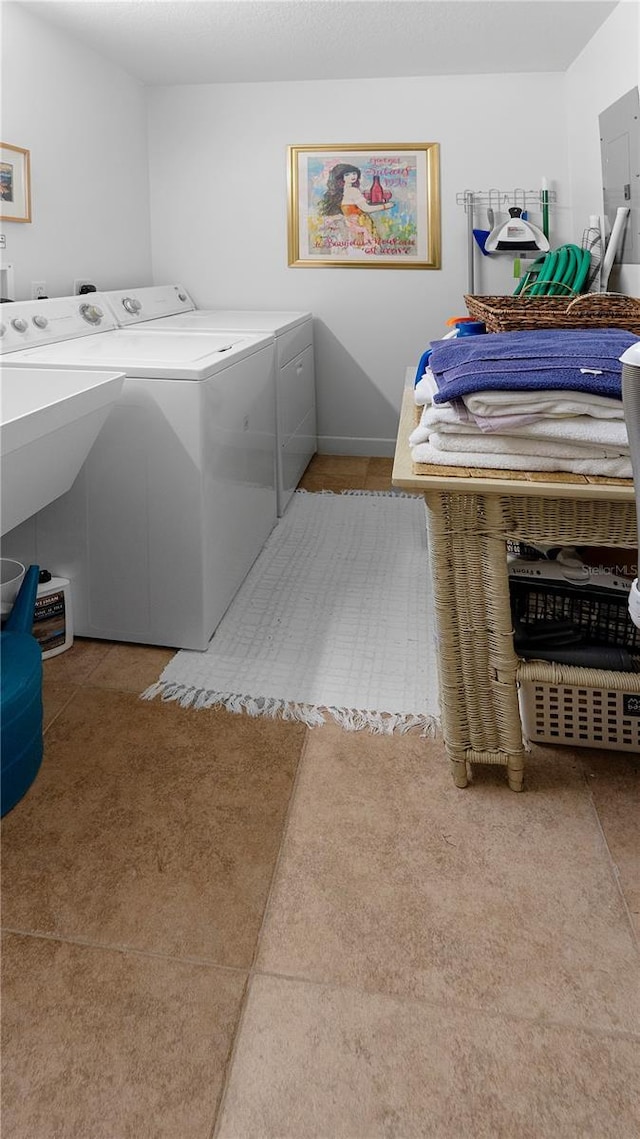 laundry room with washer and dryer and light tile patterned floors