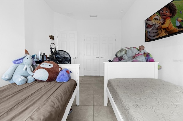 tiled bedroom with a closet