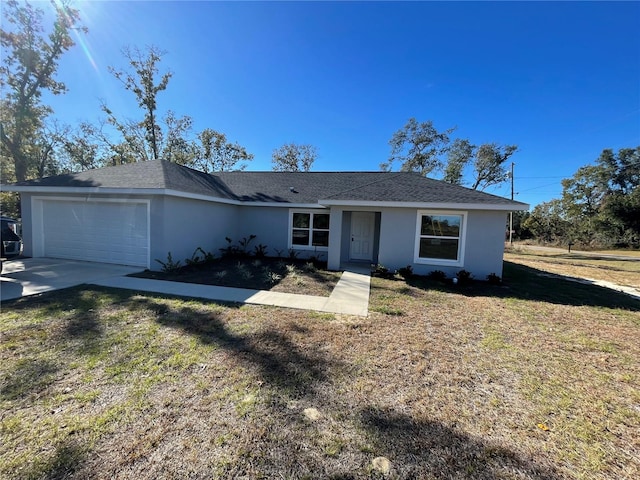 ranch-style home featuring a garage and a front lawn