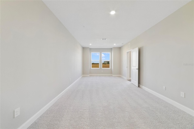 spare room with light colored carpet